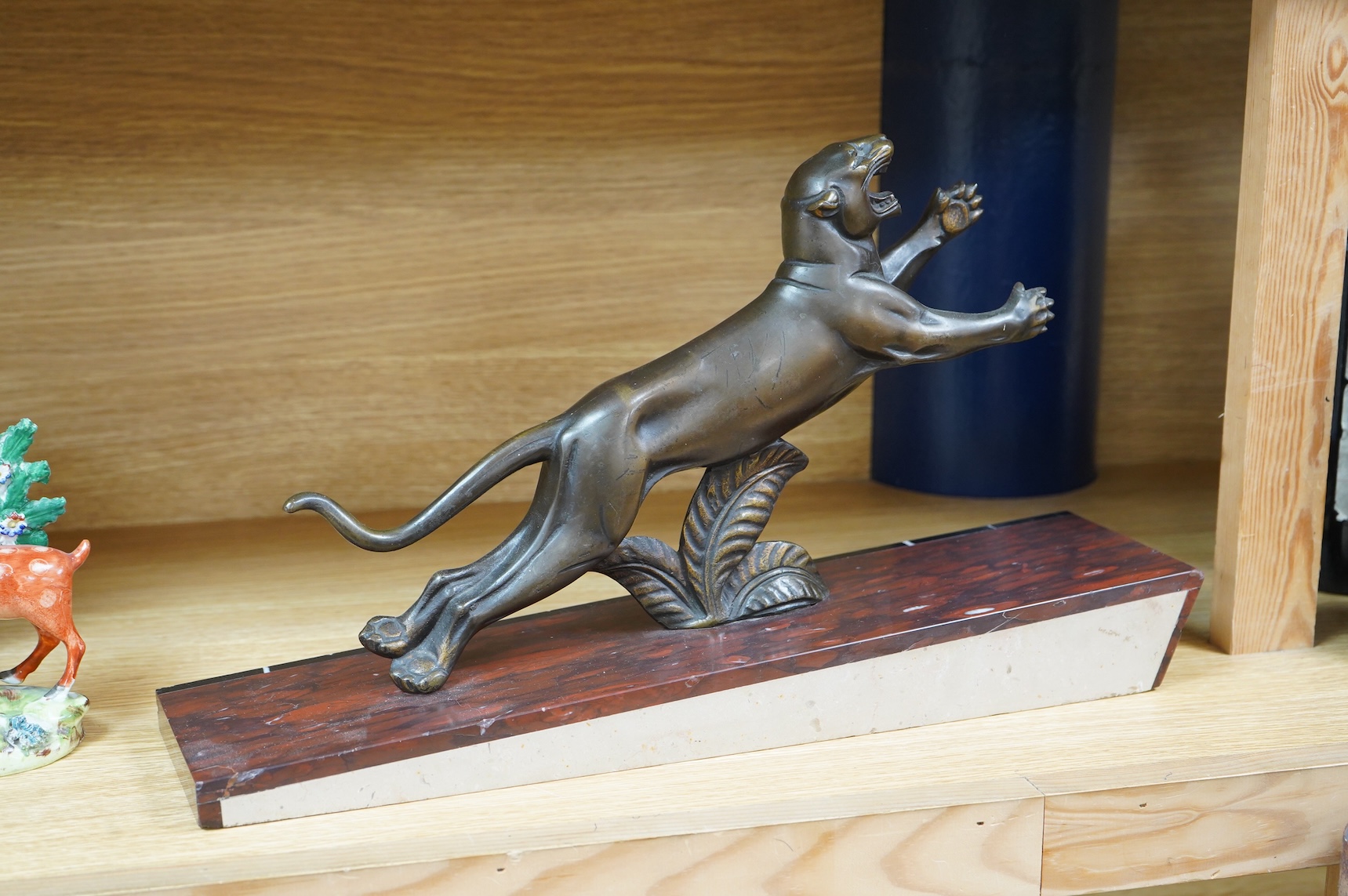 A French Art Deco bronze sculpture of a panther, raised on slanted base, 44cm wide